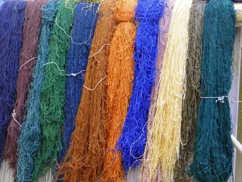 Colorful silk threads hanging, drying after preparation for intricate tradi.. Stock Photos