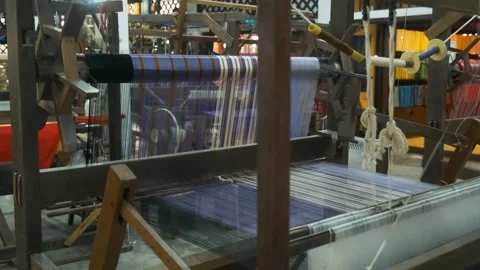Colorful silk threads on loom and wooden handlooms in traditional silk factory Stock Footage 315851213