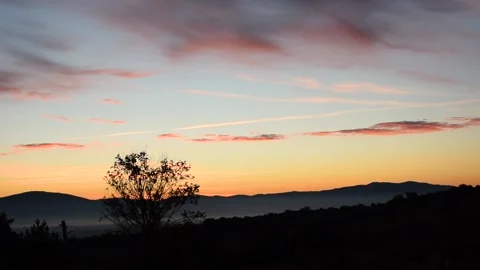 Colorful Sky with Loose Clouds Just Before Sunrise Stock Footage 248552094