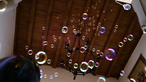 Colorful soap bubbles floating down from the ceiling Stock Footage 106236184