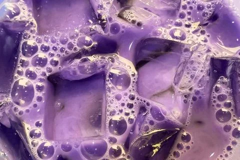 Colorful soapy liquid with bubbles closeup, cloudy water texture Stock Photos