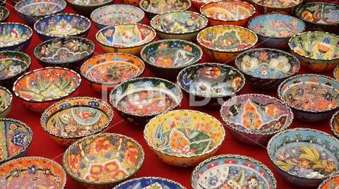 Colorful souvenirs hand painted ceramic utensils, plates and bowls on market Stock Photos