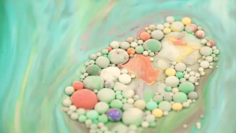 Colorful spherical objects cluster forming abstract organic shape on blurred Stock Footage 348140206