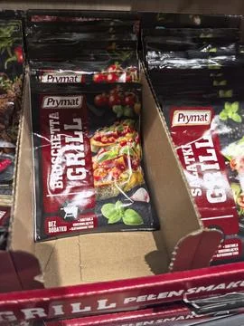 Colorful spice packets on display at a grocery store aisle Stock Photos