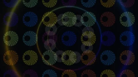 Colorful spinning circles move in a pattern on a dark Stock Footage 338011246