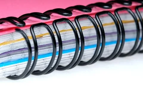Colorful spiral notebook on bright backdrop Stock Photos