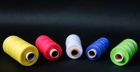 Colorful spools of thread on black background 写真素材