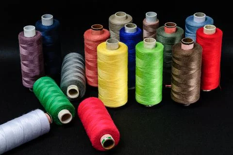 Colorful spools of thread on black background 写真素材