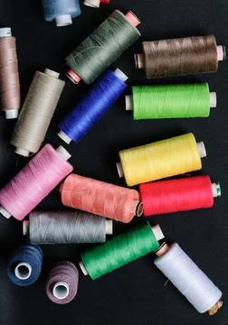 Colorful spools of thread on black background 写真素材