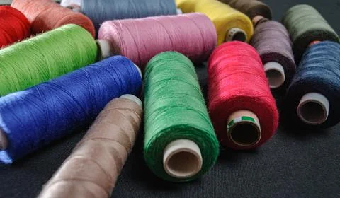 Colorful spools of thread on black background 写真素材