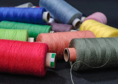 Colorful spools of thread on black background 写真素材