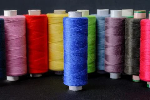 Colorful spools of thread on black background 写真素材