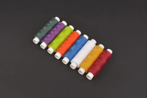 Colorful spools thread on dark background Stock Photos