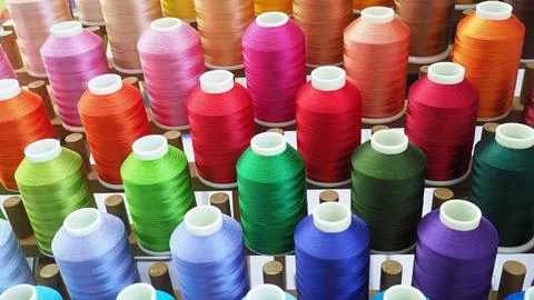 A colorful spools of thread. The threads are organized in rows . Stock Photos