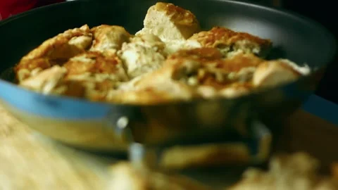 Colorful spoon coating roasted poultry with pale gravy in action, 4K Stock Footage 341105884