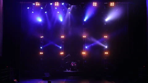 Colorful spotlight on an empty concert stage in the dark. Free stage with lights Stock Footage 105353544