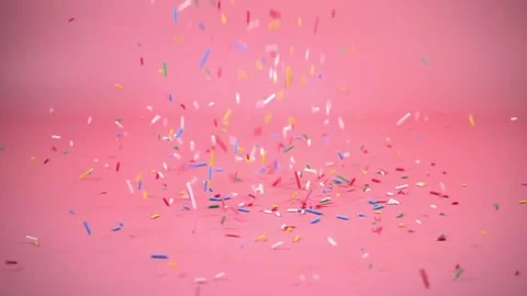Colorful sprinkles falling on pink background, decoration for cake and bake.. Stock Footage 305785258