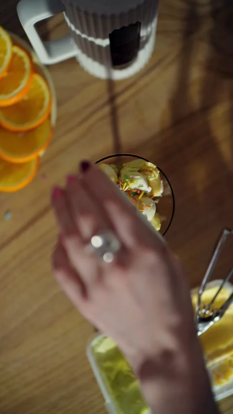 Colorful sprinkles falling on scoops of cold ice cream Video stock 331775033