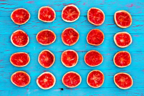 Colorful squeezed ruby grapefruit background Stock Photos