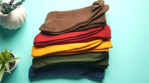 Colorful stack of warm knitted socks displayed on a table Stock Footage 310882736
