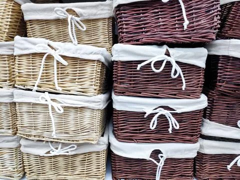 Colorful stack of wicker baskets boxes for towels and home stuff on shelf i.. Stock Photos