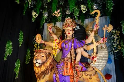 Colorful statue of Goddess Durga with multiple arms holding weapons Stock Photos