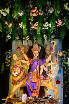 Colorful statue of Goddess Durga with multiple arms holding weapons Stock Photos