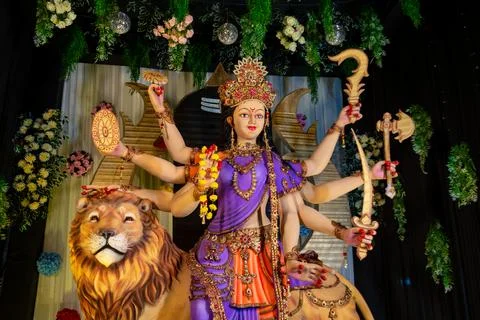 Colorful statue of Goddess Durga with multiple arms holding weapons Stock Photos