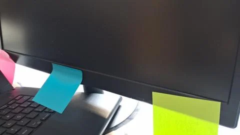 Colorful sticky notes on a computer screen. Office reminders attached to a Stock Photos