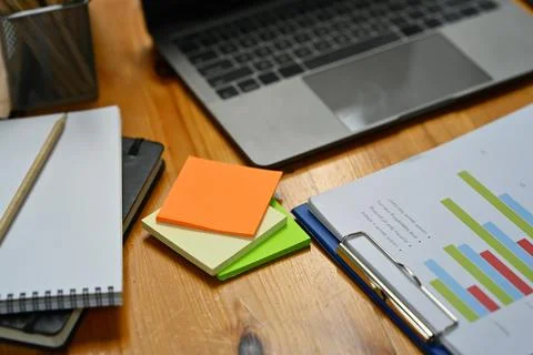 Colorful sticky notes, financial document, notebook and laptop computer on Stock Photos