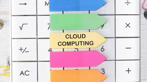 Colorful sticky notes labeled for cloud computing are arranged on a calculato Stock Photos