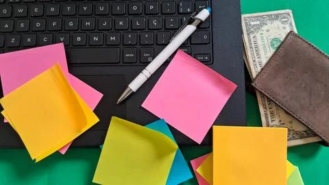 Colorful sticky notes placed on a black laptop keyboard surface Stock Photos