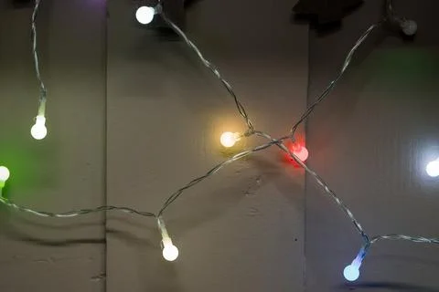 Colorful String Lights Illuminating a Dark Wall Stock Photos