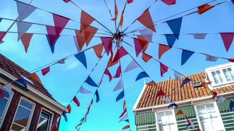 Colorful string pennant triangle flags used for celebrations against a clear Stock Footage 90410799