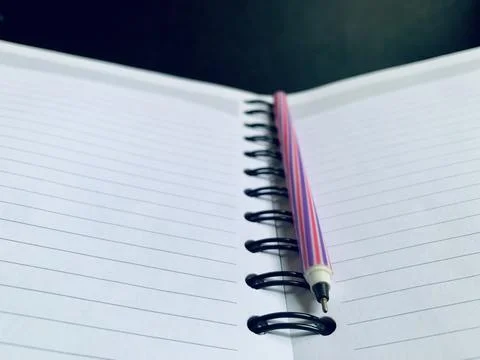 Colorful Striped Pen on Open Lined Spiral Notebook Close Up High Angle Stock Photos