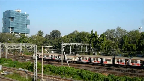 Colorful suburban local Train speeding near Dadar railway station, Mumbai India Stock Footage 98917458