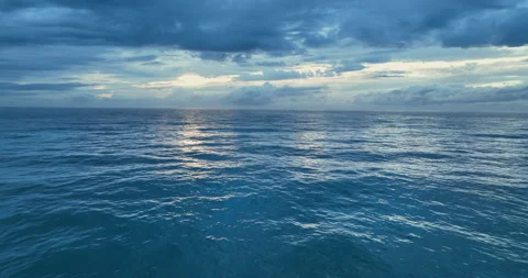 Colorful sunset above the ocean surface. Aerial view of sea surface during the Stock Footage 220790807