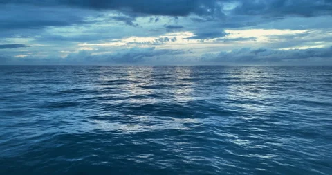 Colorful sunset above the ocean surface. Aerial view of sea surface during the Stock Footage 220879545