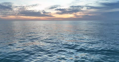Colorful sunset above the ocean surface. Aerial view of sea surface during the Stock Footage 221318166
