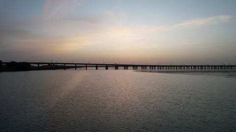 Colorful sunset aerial of cable stayed bridge over river in China Stock Footage 337759447