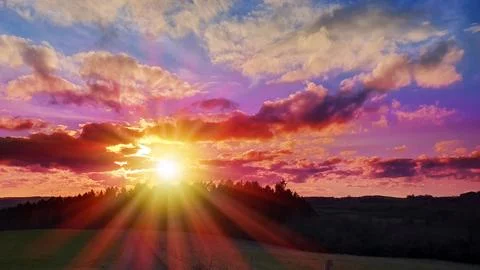 Colorful sunset background with abstract clouds and trees. Photos