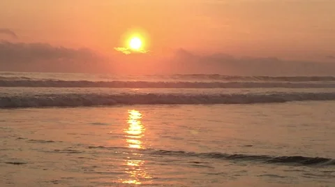 Colorful Sunset at Beach, Sun Setting Above Purple Ocean Stock Footage 49075753