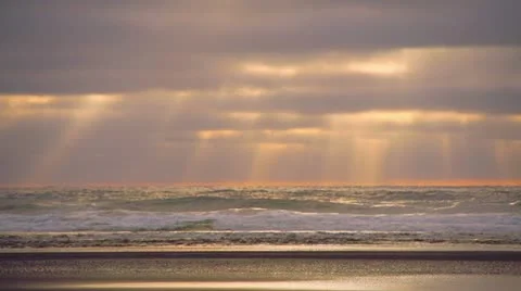 Colorful Sunset Clouds over Crashing Waves Beach Scene with Rays Stock Footage 22221553