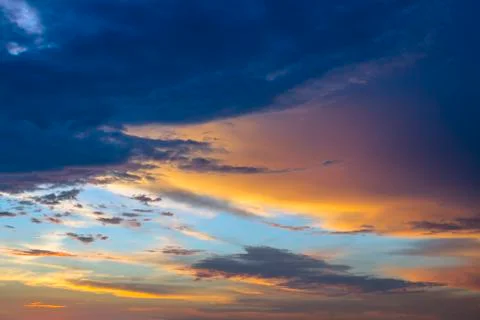 Colorful sunset. Dramatic sky background with dark clouds. Stock Photos