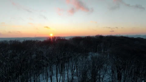 Colorful sunset to nightfall time lapse over a winter forest Stock Footage 252290720