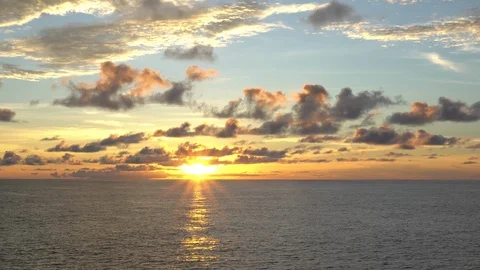 Colorful sunset in the open ocean under a cloudy sky Stock Footage 116619289
