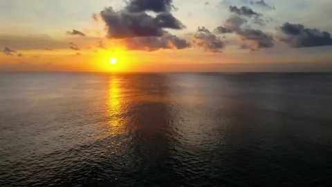Colorful sunset with the reflection of sunshine in the ocean and cloudy sky Stock Footage 139100065