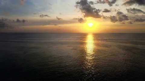 Colorful sunset with the reflection of sunshine in the ocean and cloudy sky Stock Footage 139100077