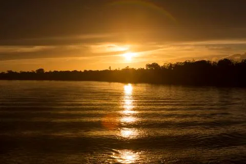 Colorful sunset on the river Amazon in the rainforest, Brazil Stock Photos