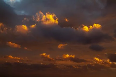 Colorful sunset sky with dramatic orange clouds. Only sky, no land. Stock Photos